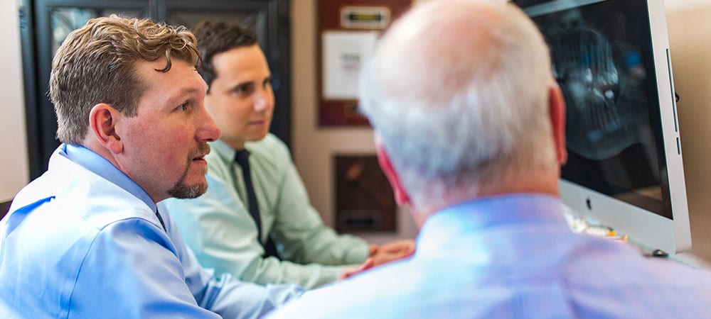 The Tampa periodontics doctors on a computer